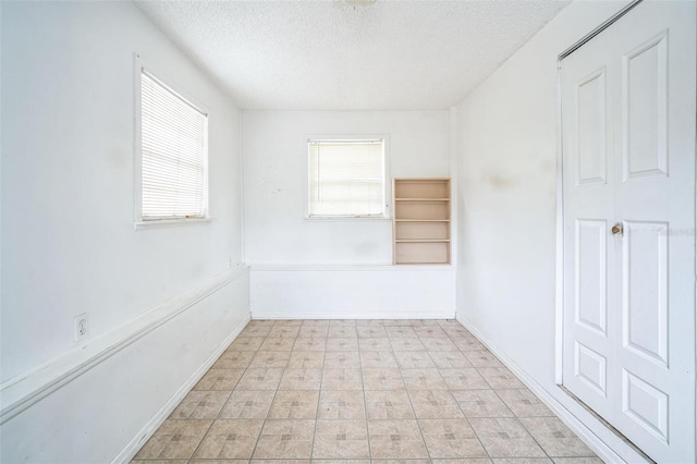 empty room featuring a textured ceiling