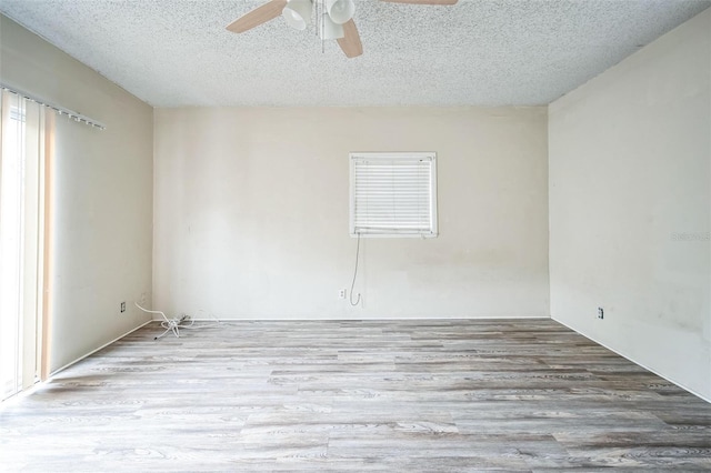 spare room featuring ceiling fan, light hardwood / wood-style flooring, and a textured ceiling