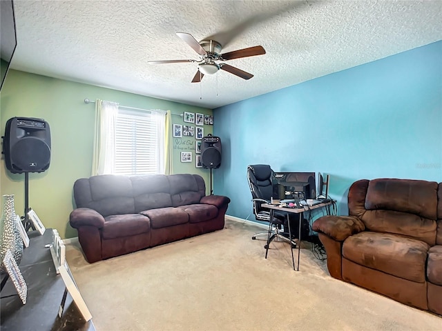 carpeted living room with ceiling fan and a textured ceiling