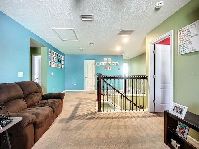 carpeted living room featuring a textured ceiling