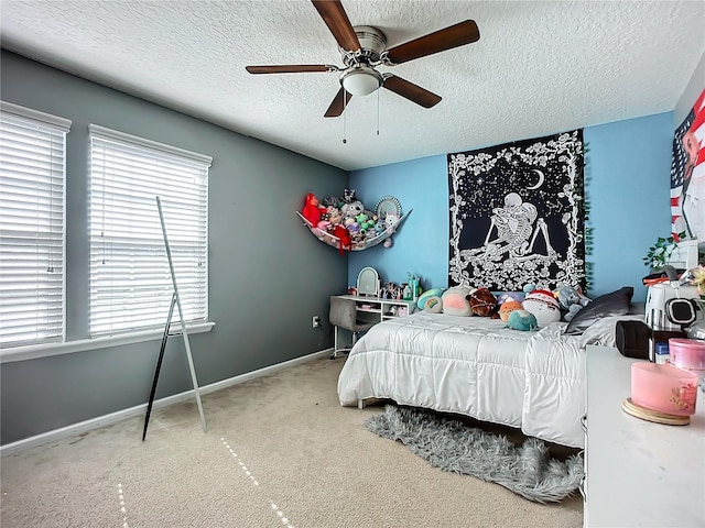 carpeted bedroom with multiple windows, ceiling fan, and a textured ceiling