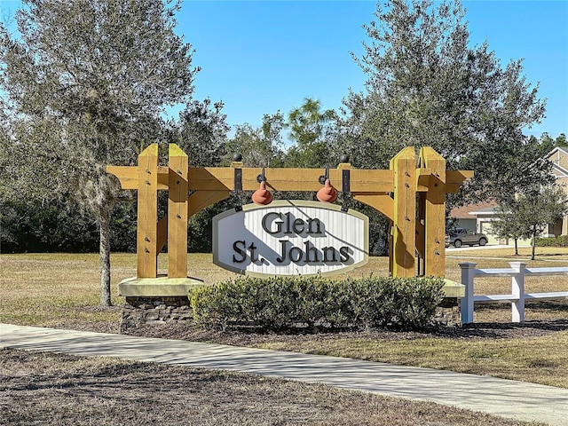 community sign featuring a lawn