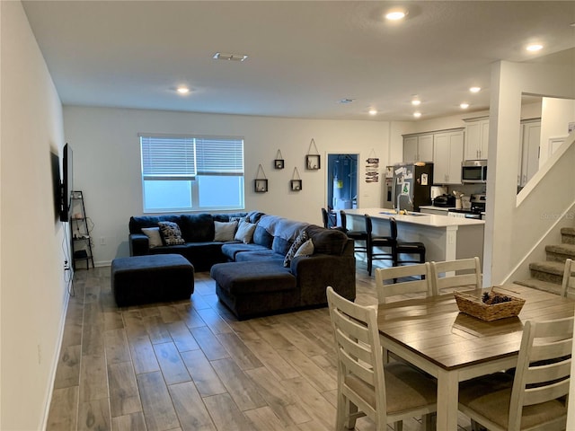 dining space with light hardwood / wood-style flooring