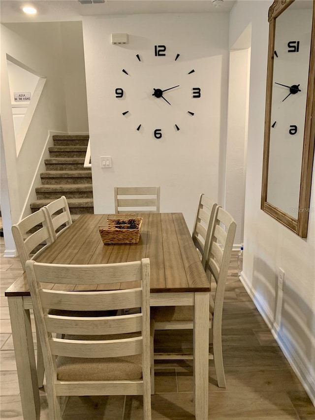 dining space with wood-type flooring