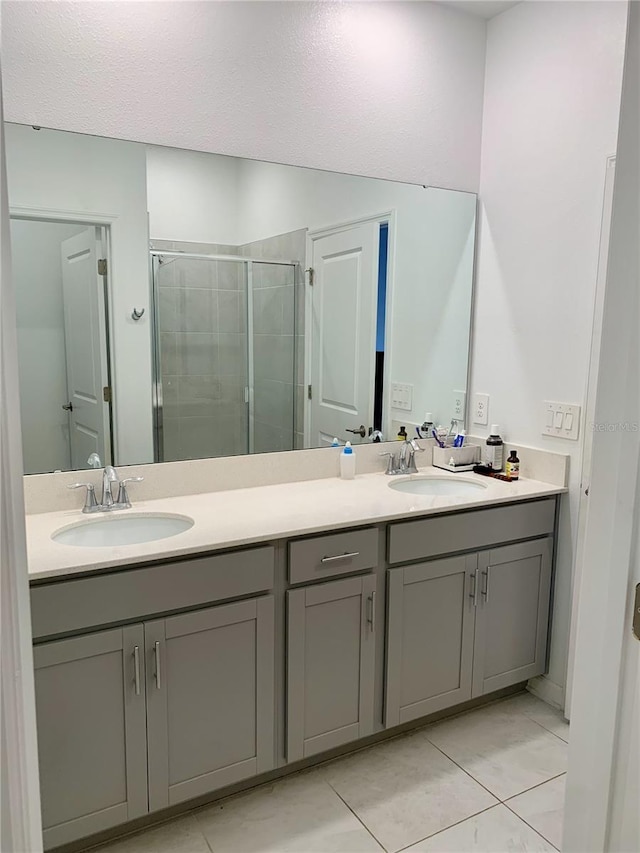 bathroom featuring vanity, tile patterned floors, and walk in shower