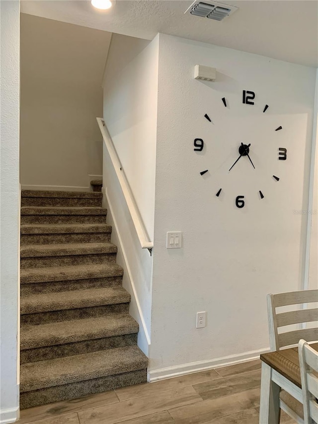 staircase with wood-type flooring