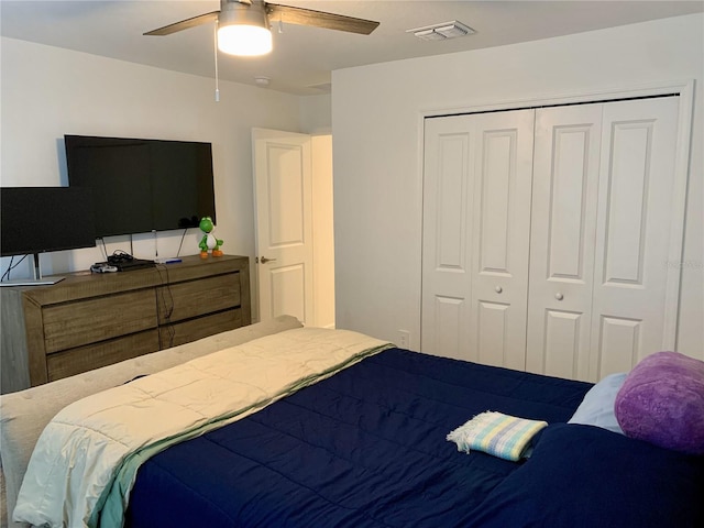 bedroom with ceiling fan and a closet