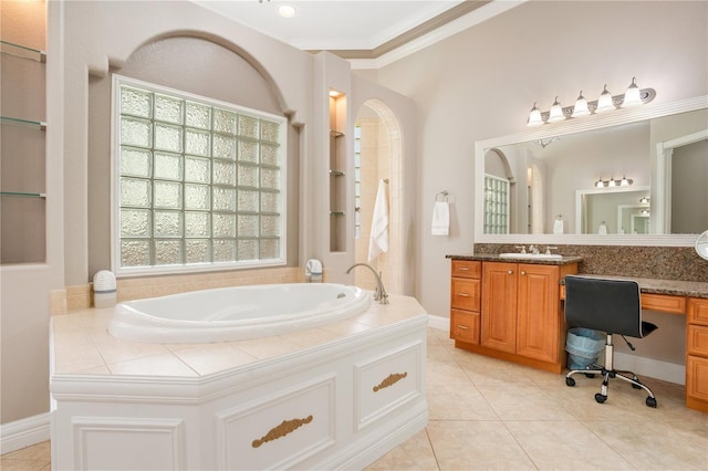 bathroom with ornamental molding, tile patterned floors, a bathtub, and vanity