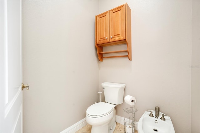 bathroom featuring a bidet, toilet, and tile patterned flooring