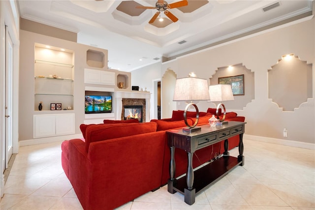 living room featuring ceiling fan, a high end fireplace, ornamental molding, light tile patterned flooring, and built in shelves