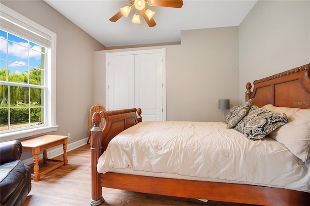 bedroom featuring a closet, ceiling fan, and light wood-type flooring