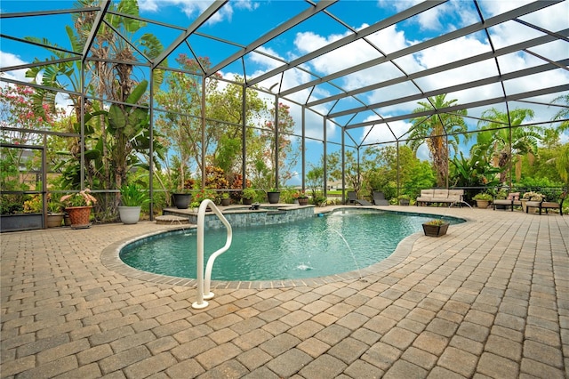 view of pool with a patio, an in ground hot tub, and glass enclosure