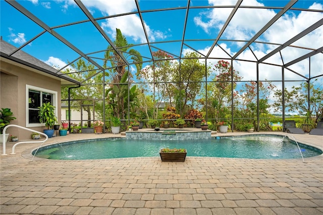 view of swimming pool with pool water feature, a jacuzzi, a patio area, and a lanai