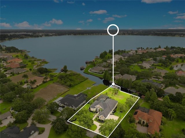 birds eye view of property with a water view