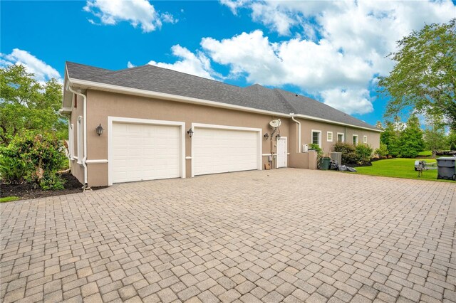 ranch-style house with a garage and a front yard