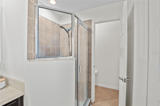 bathroom with vanity and a shower with shower door