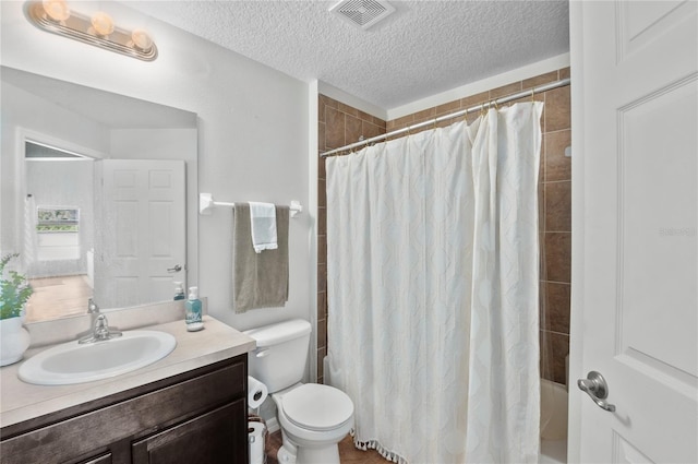 full bathroom featuring vanity, toilet, shower / bath combo with shower curtain, and a textured ceiling