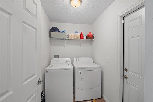 clothes washing area featuring independent washer and dryer and a textured ceiling