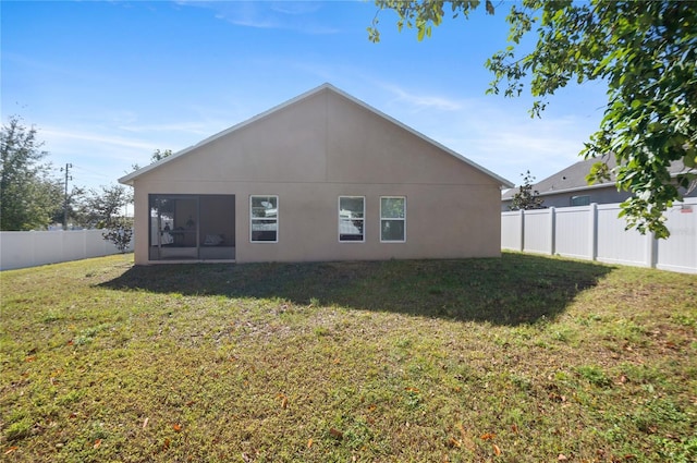 rear view of house with a lawn