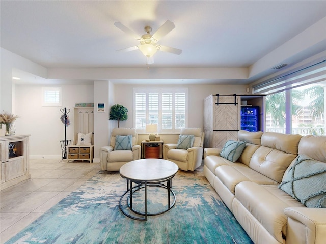 living room featuring a healthy amount of sunlight, light tile patterned floors, and ceiling fan