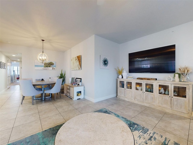 tiled living room with a notable chandelier