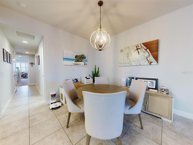 dining room with light tile patterned floors and a notable chandelier