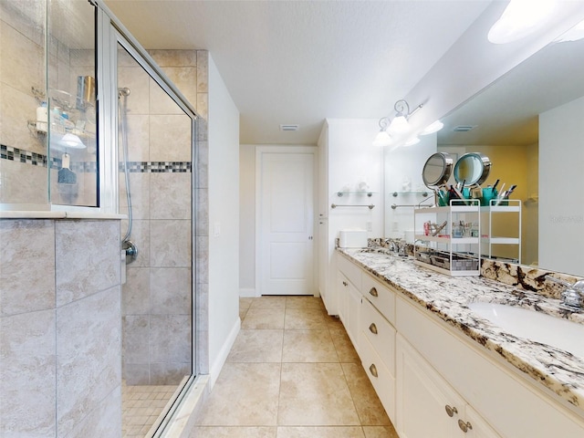 bathroom featuring vanity, tile patterned floors, and walk in shower