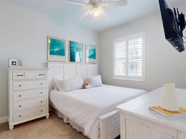 bedroom featuring light colored carpet and ceiling fan