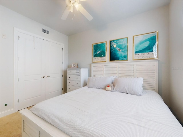 carpeted bedroom featuring a closet and ceiling fan