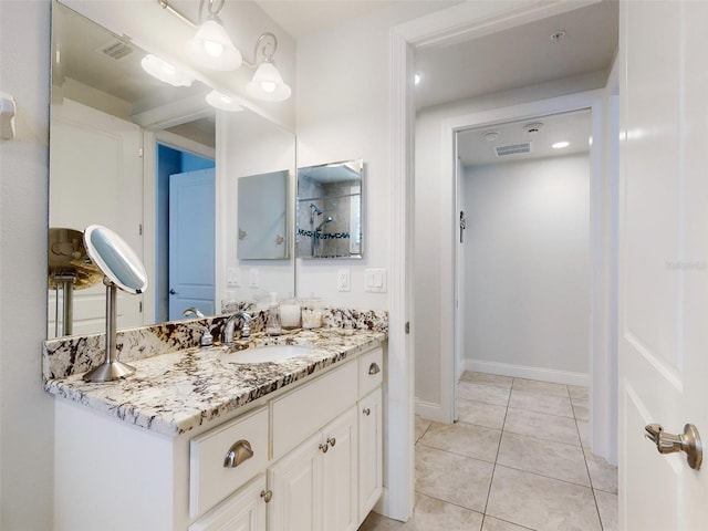 bathroom with tile patterned flooring and vanity