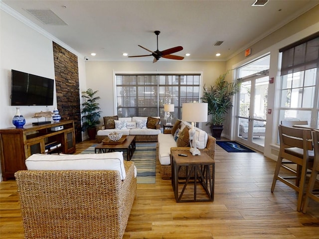 living room featuring ornamental molding, ceiling fan, light wood-type flooring, and french doors