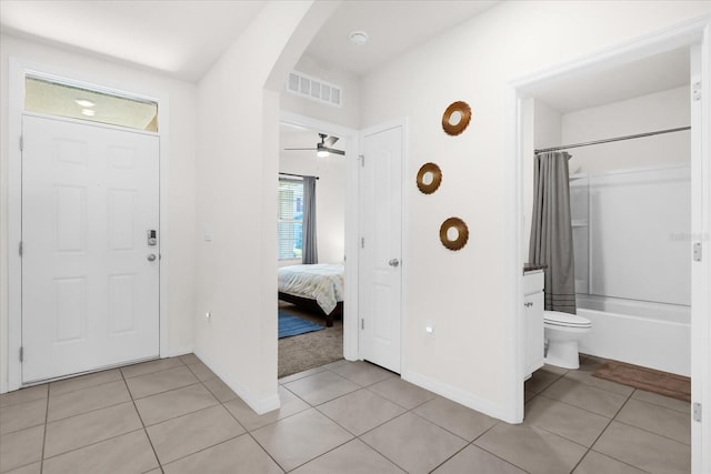 foyer featuring ceiling fan and light tile patterned floors