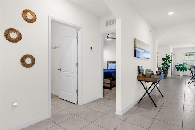 hall featuring light tile patterned floors