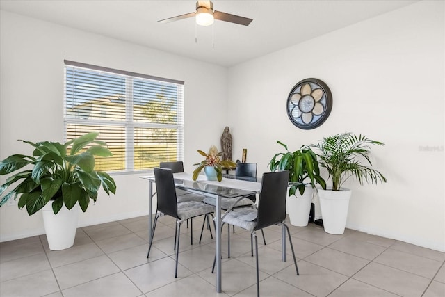 tiled dining space with ceiling fan