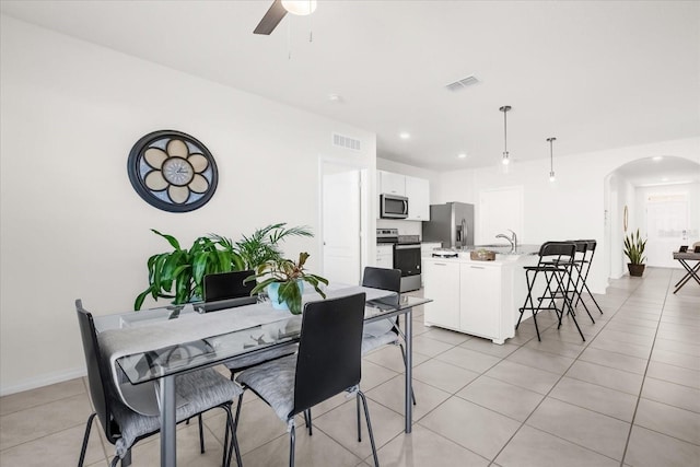 tiled dining room with sink and ceiling fan