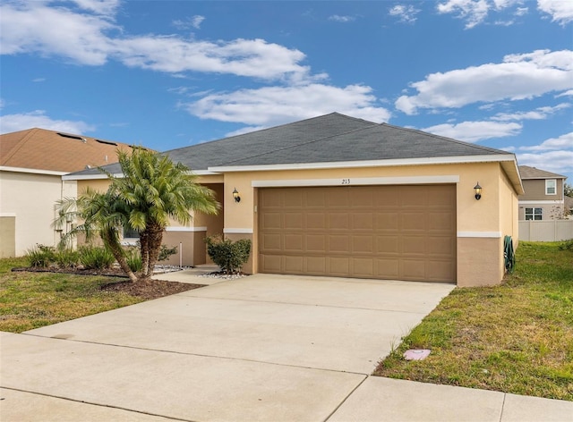 ranch-style home with a garage and a front yard