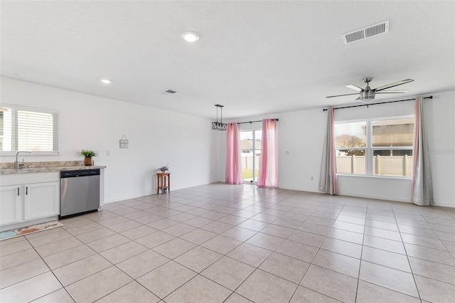 unfurnished room featuring ceiling fan, sink, a textured ceiling, and light tile patterned floors