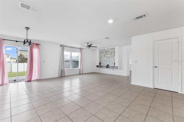 empty room featuring light tile patterned floors and ceiling fan