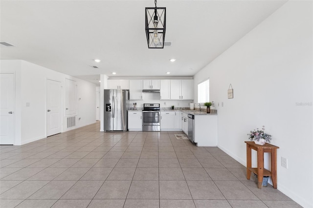 kitchen with appliances with stainless steel finishes, pendant lighting, white cabinetry, sink, and light tile patterned floors