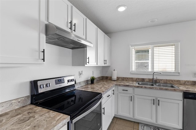 kitchen featuring white cabinetry, appliances with stainless steel finishes, sink, and light tile patterned floors