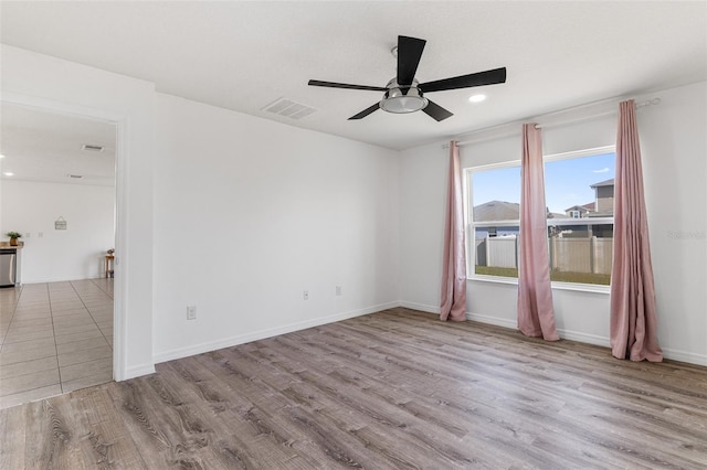 spare room with ceiling fan and light hardwood / wood-style floors