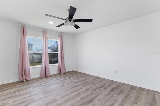 spare room featuring ceiling fan and light hardwood / wood-style floors