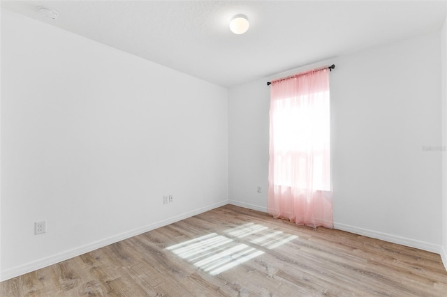 empty room with light hardwood / wood-style flooring