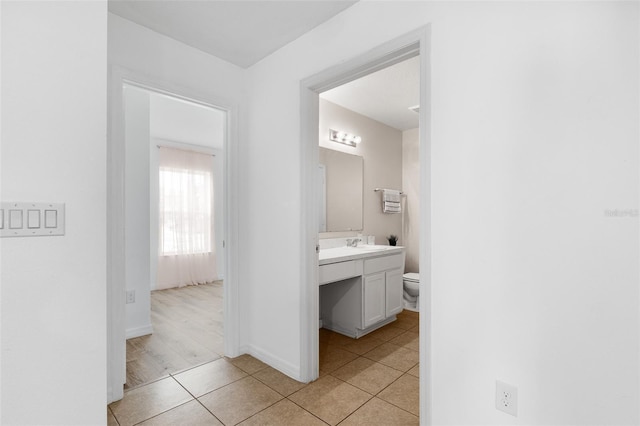 bathroom with vanity, toilet, and tile patterned flooring