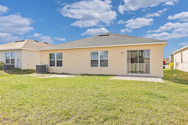 back of property featuring central AC unit, a yard, and a patio area