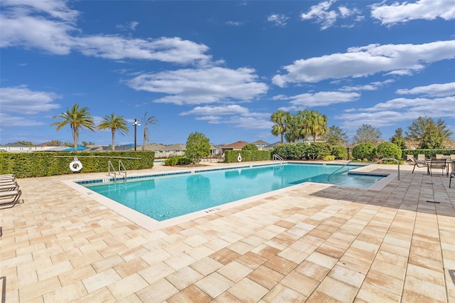 view of swimming pool with a patio area and a jacuzzi