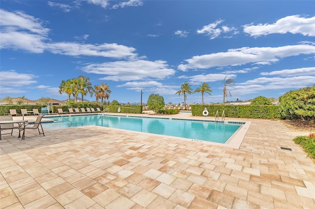 view of swimming pool featuring a patio