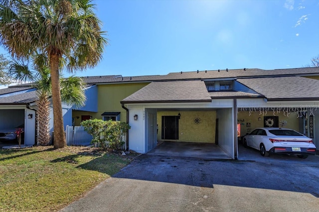 view of front facade with a carport and a front yard