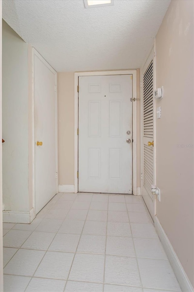 hall featuring a textured ceiling