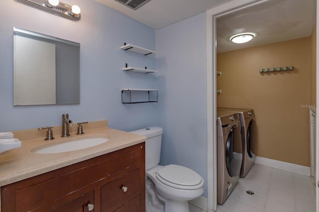 bathroom with vanity, tile patterned floors, washing machine and dryer, and toilet